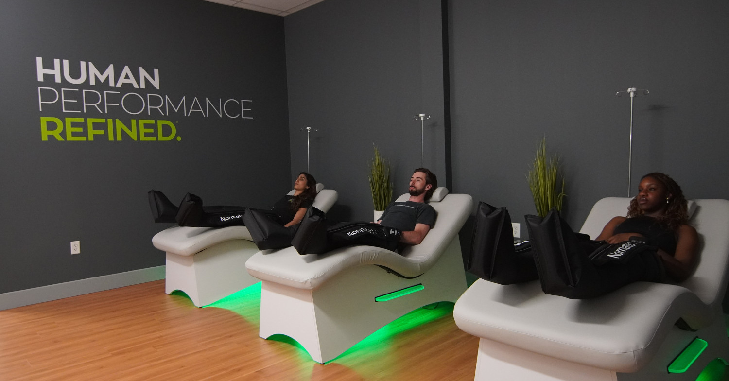 people relaxed in chairs with compression boots on